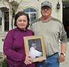 Virginia Farver and her husband Craig (holding a picture of their son)